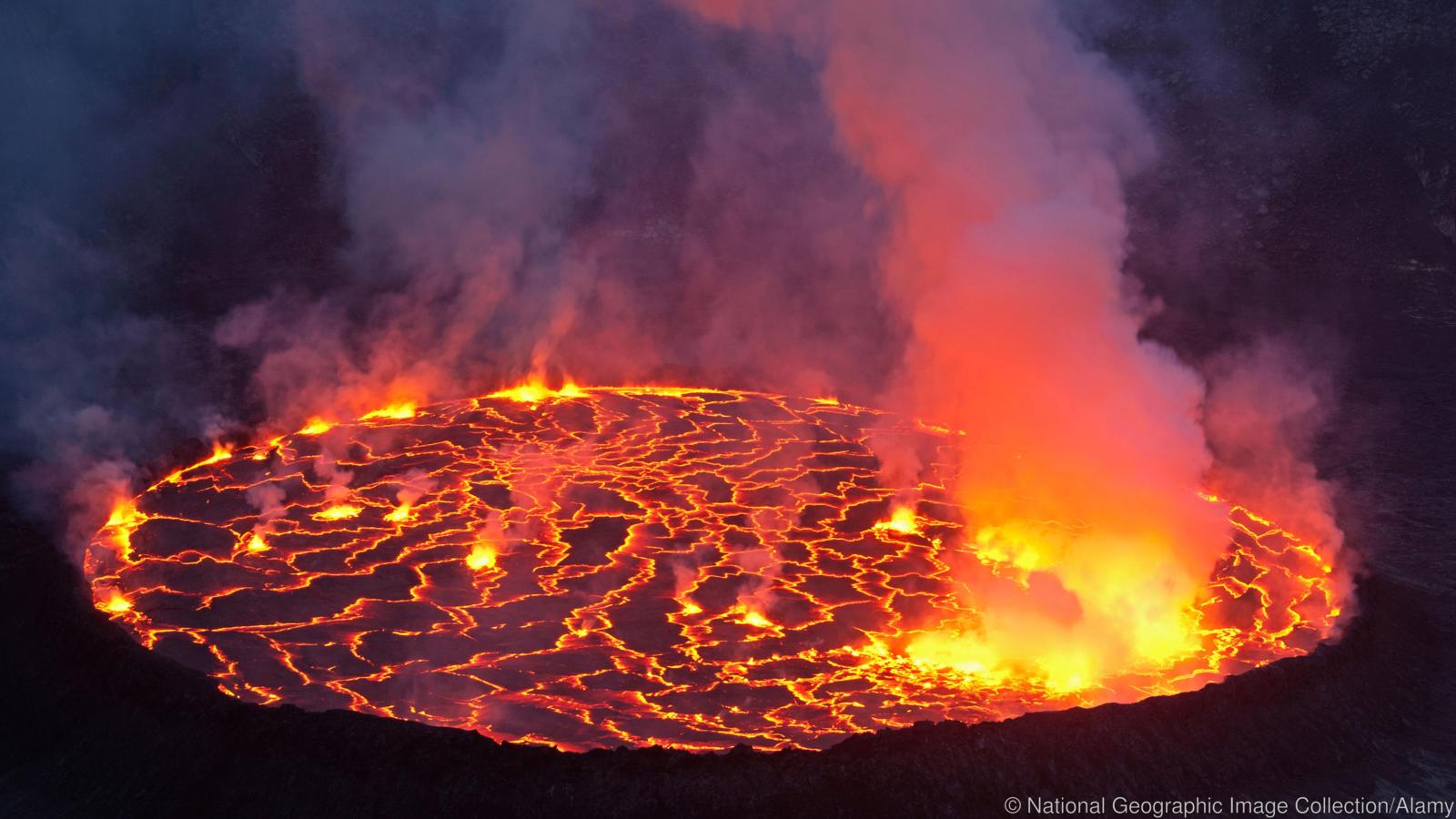 Molten rock cools and forms plates on the surface of a lava lake.